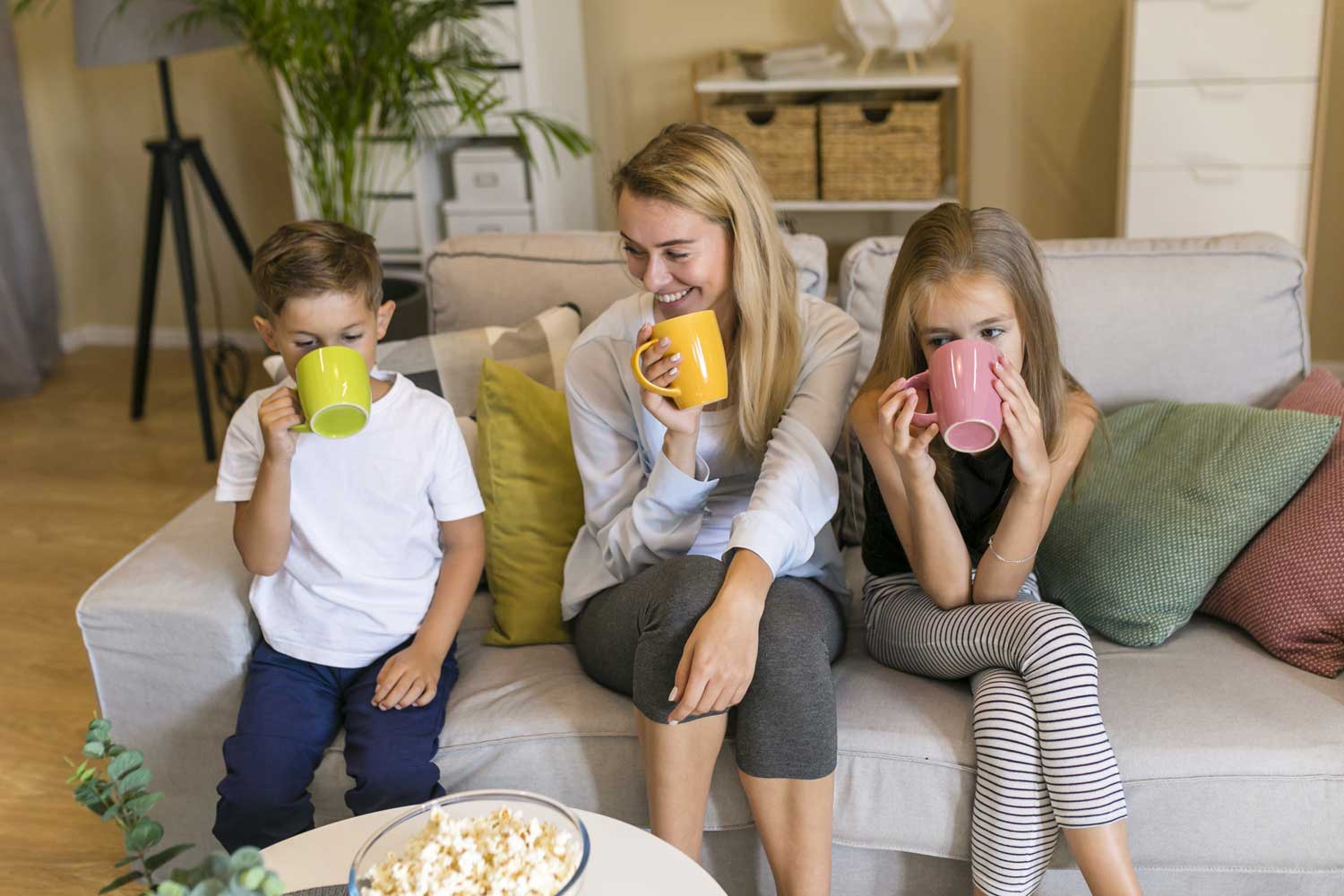Mother her children drinking from cups