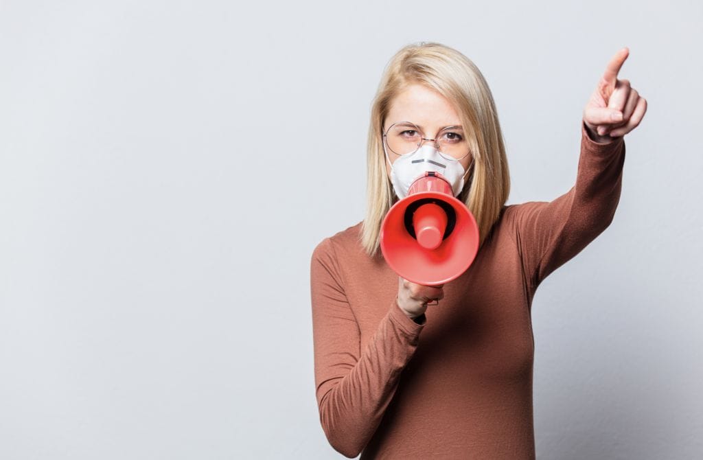 shouting through a megaphone to announce something