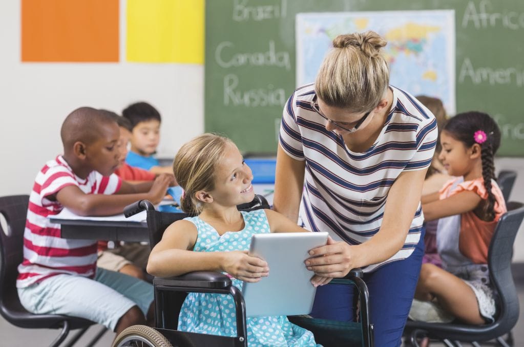 schoolgirl teacher using digital tablet classroom sm