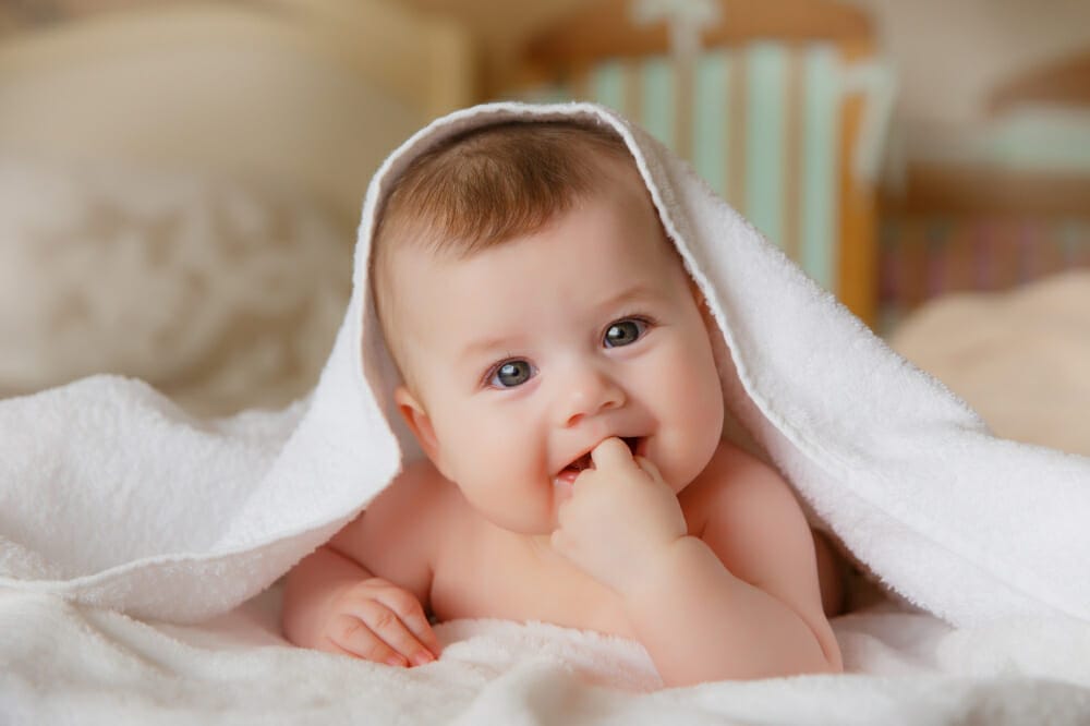 happy smiling baby towel after bathing