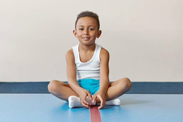 Childhood, active lifestyle and health concept. handsome cheerful african american little boy wearing socks