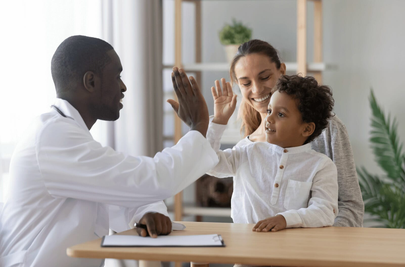 Family high fiving indoors