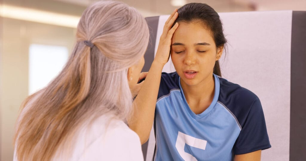 A concussed soccer player seeks help at the doctor's office.