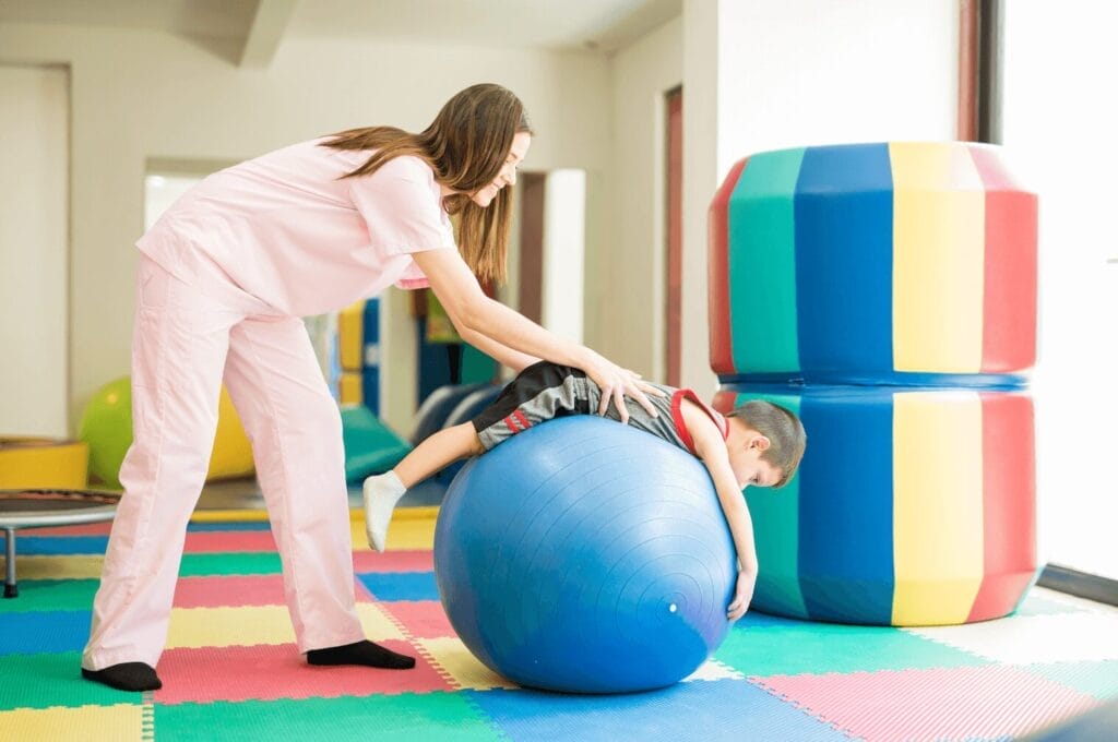 physical therapy with PT and Child on ball